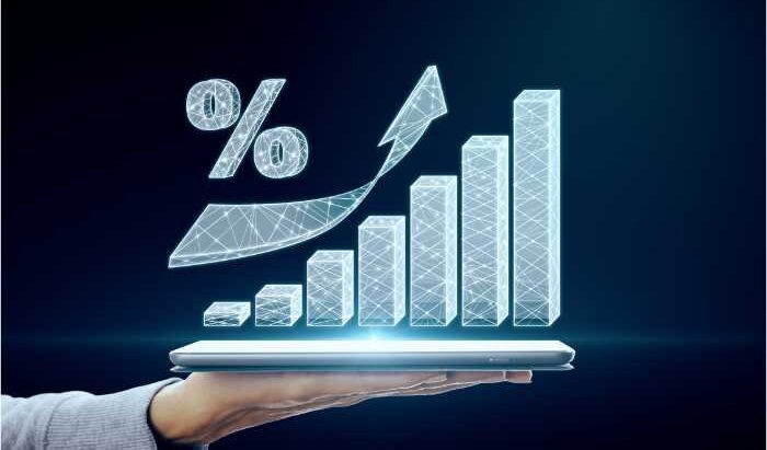 transpiring from the horizontal screen of a handheld tablet is '%', and upwards arrow, and bar-graph of increasing height